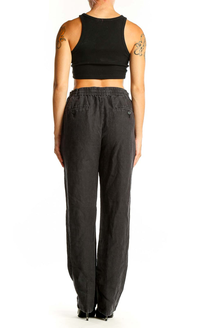 Side view of model wearing Vince black hemp pants with crop top