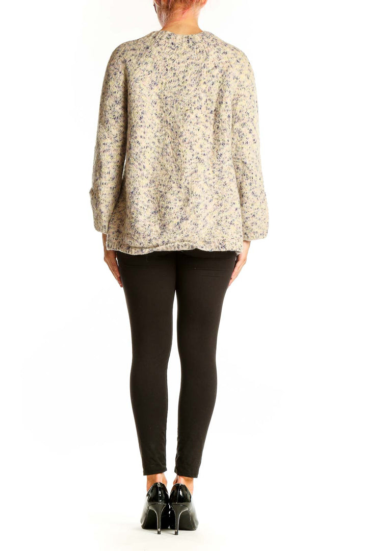 Side view of Lou & Grey beige speckled oversized knit sweater on model