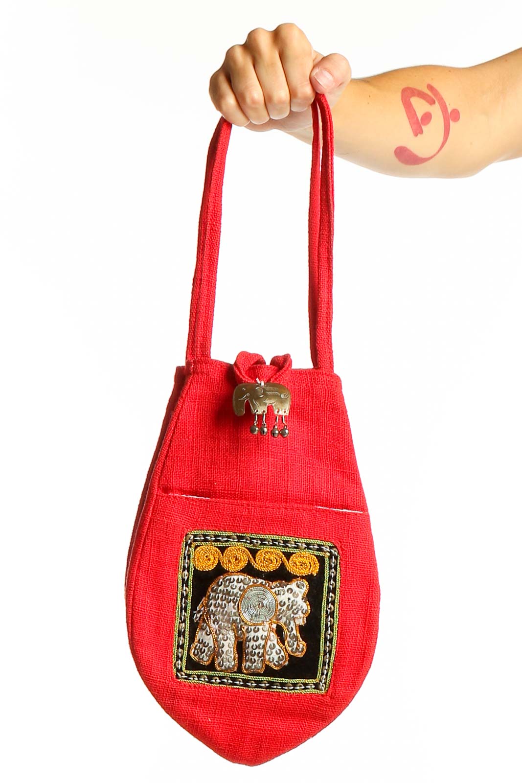 Front view of red clutch bag with embroidered elephant design