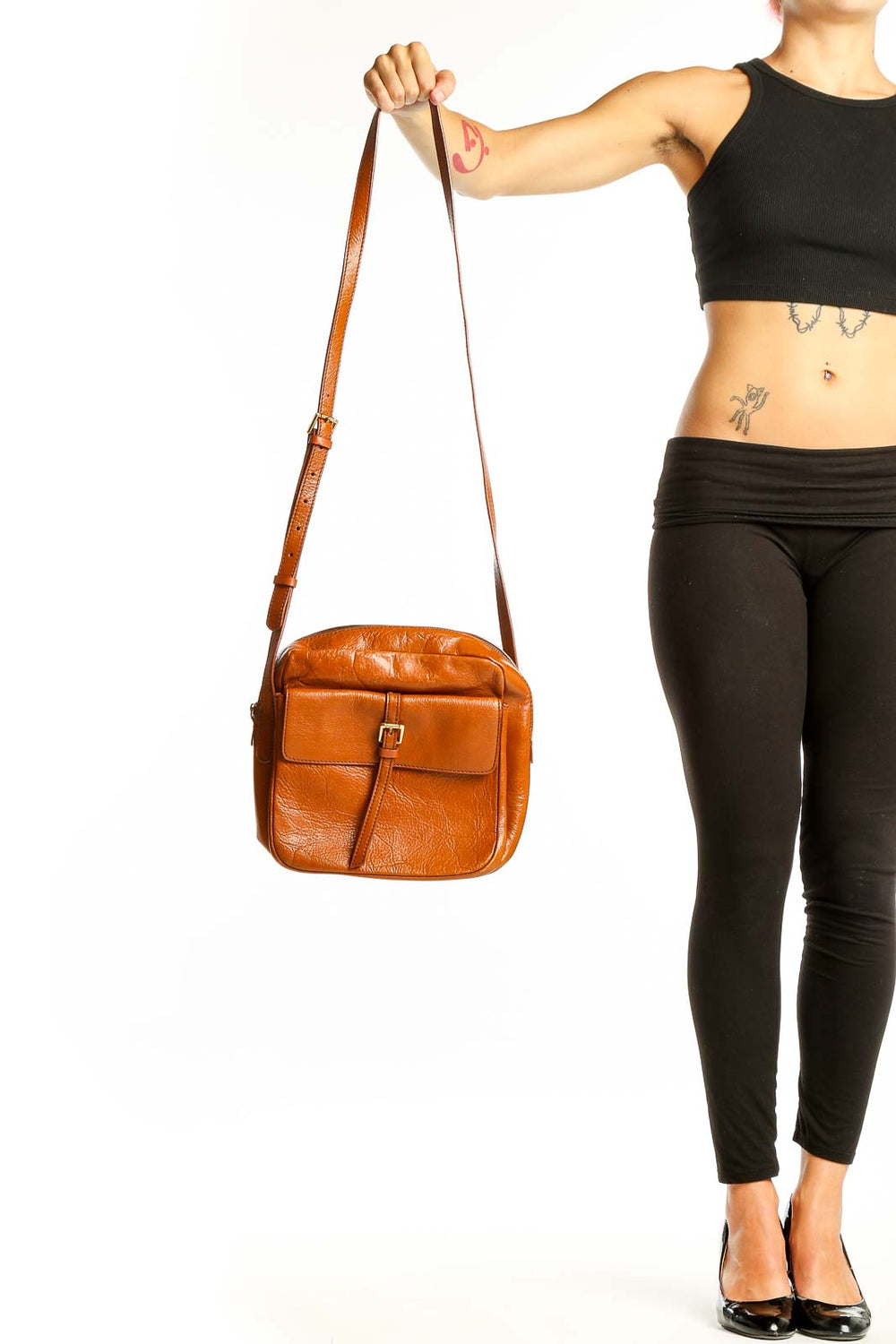 Front view of tan leather SilkRoll crossbody bag with buckle detail
