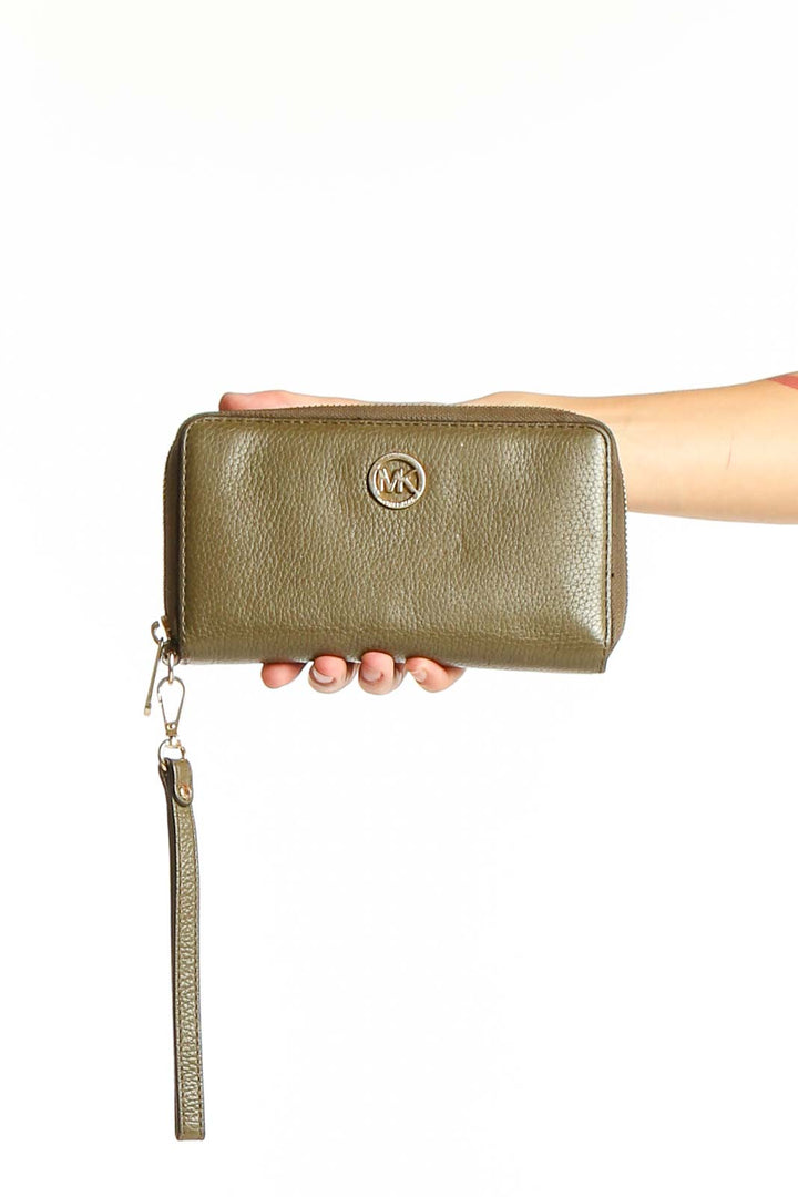 Front view of Michael Kors olive leather zip-around wallet held in hand