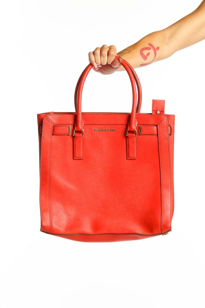 Front view of red Michael Kors leather tote bag