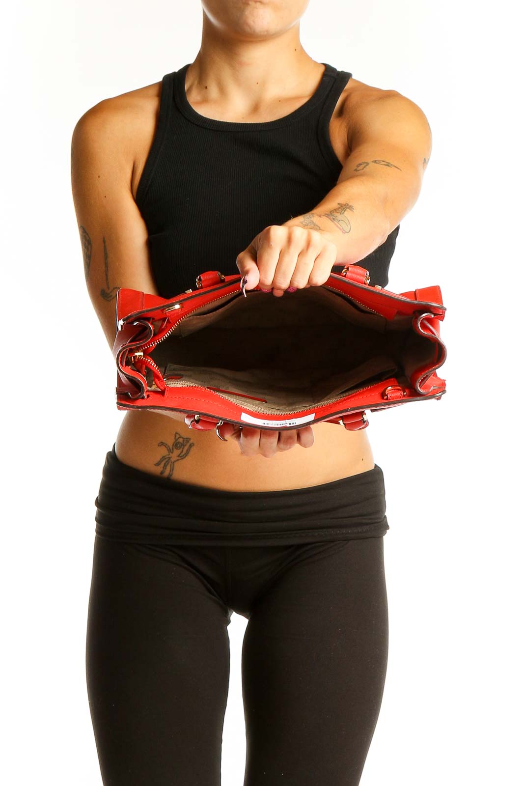 Model holding red Michael Kors leather tote bag