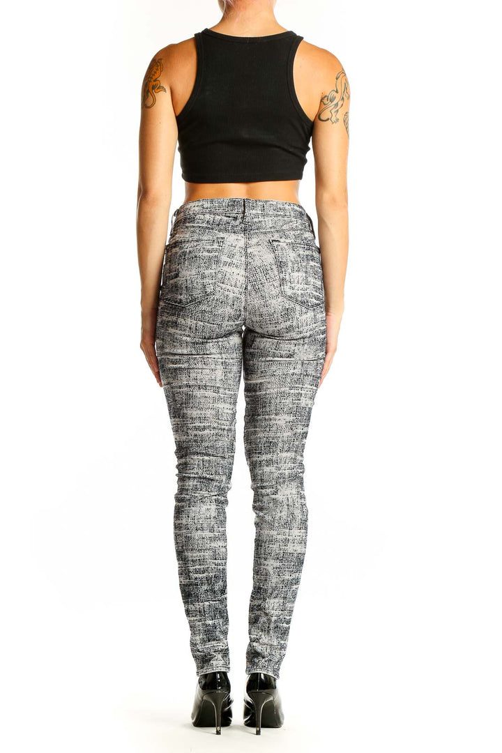 Back view of J Brand gray textured skinny jeans on model with black crop top