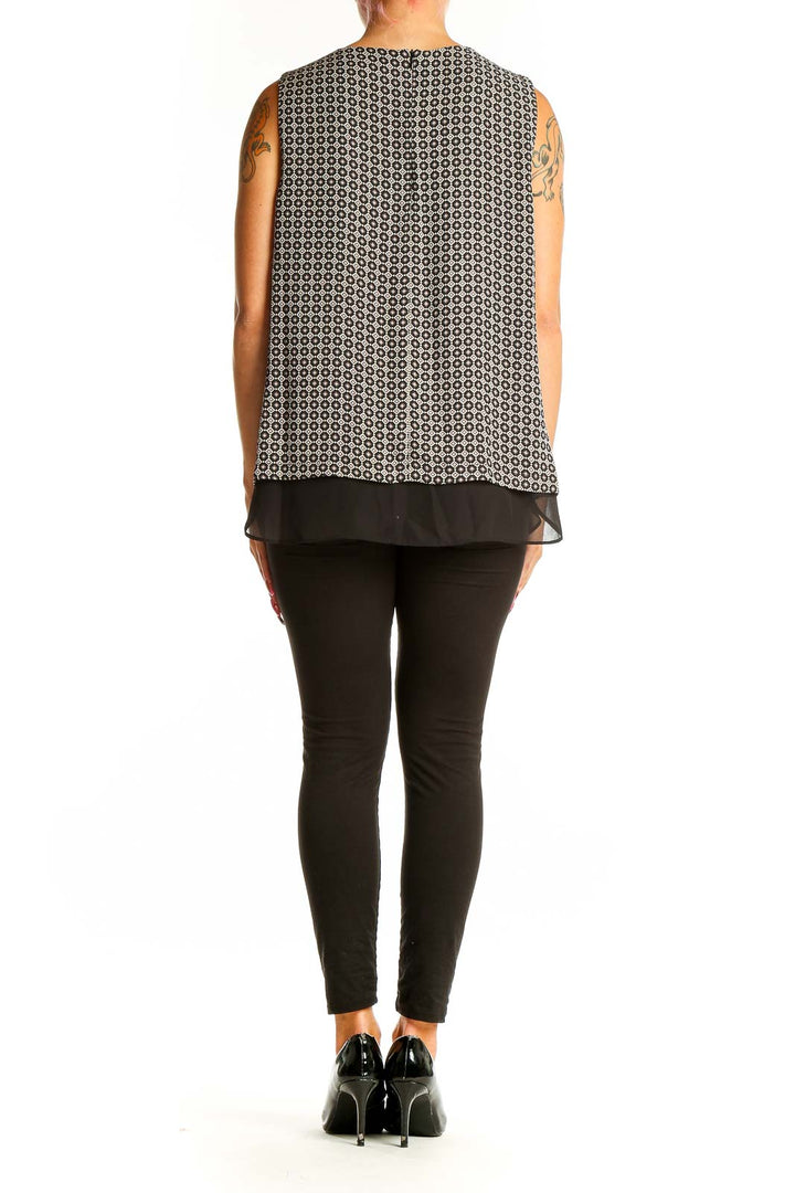 Back view of Rose + Olive black and white geometric print sleeveless top with layered design