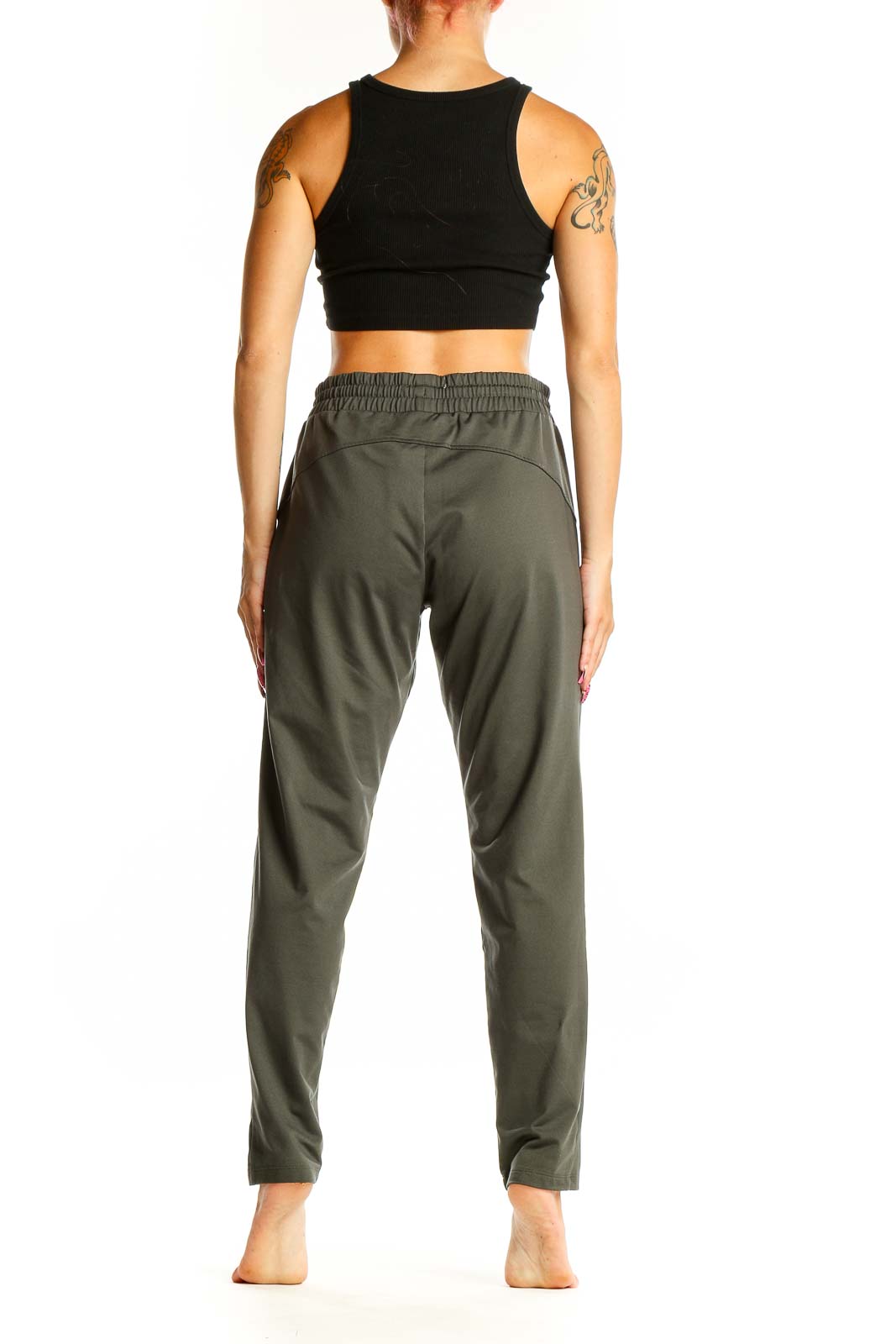 Side view of woman wearing olive green Athleta activewear pants and black crop top