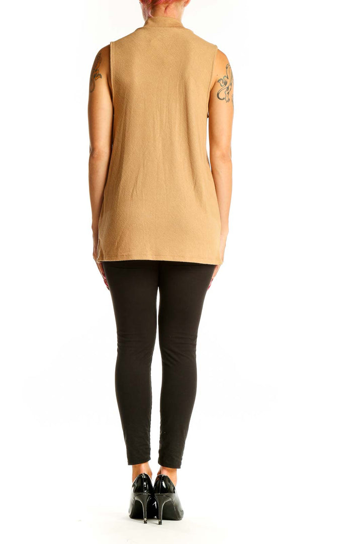 Side view of camel sleeveless mock neck top from Banana Republic on model