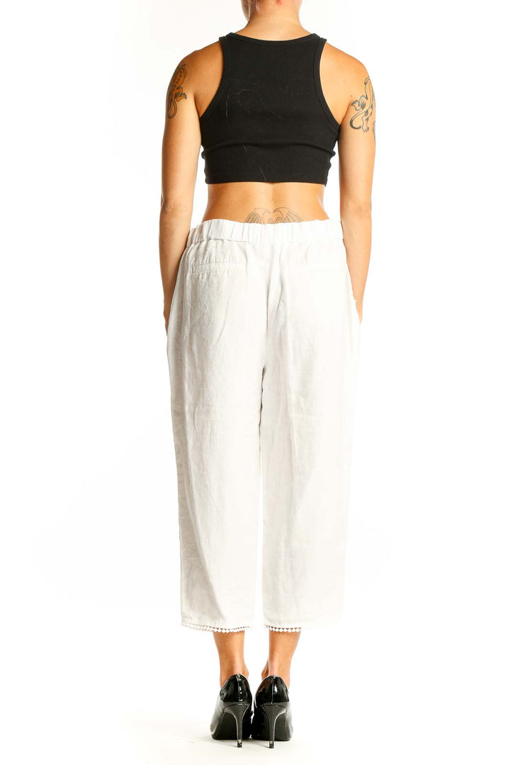 Side view of white linen cropped wide-leg pants from Talbots on model
