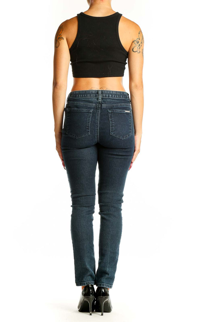 Side view of Michael Kors dark blue slim-fit jeans on model