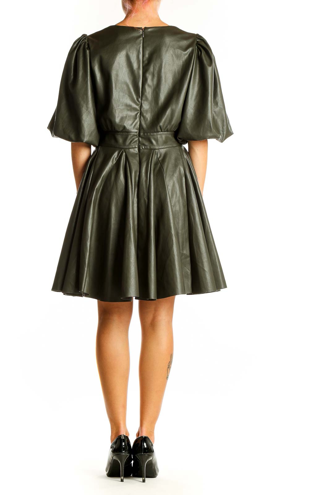 Side view of olive faux leather puff sleeve dress showing flared skirt