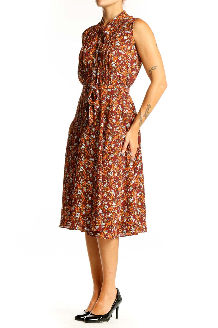 Front view of Nanette Lepore rust floral print sleeveless midi dress with tie belt
