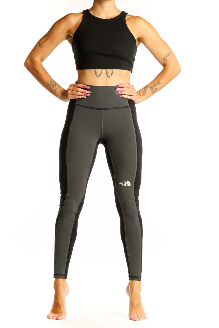 Front view of The North Face dark green high-waisted leggings