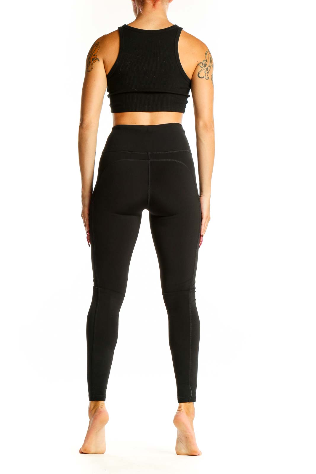 Side view of woman wearing The North Face dark green high-waisted leggings