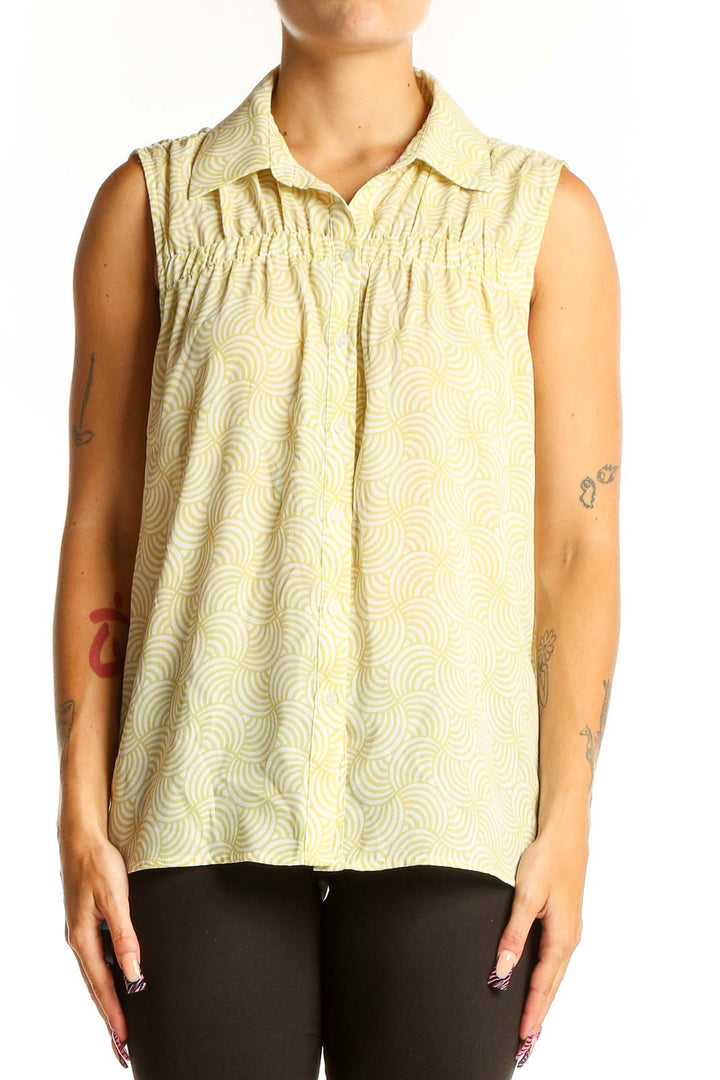 Front view of Pleione yellow sleeveless blouse with swirl pattern