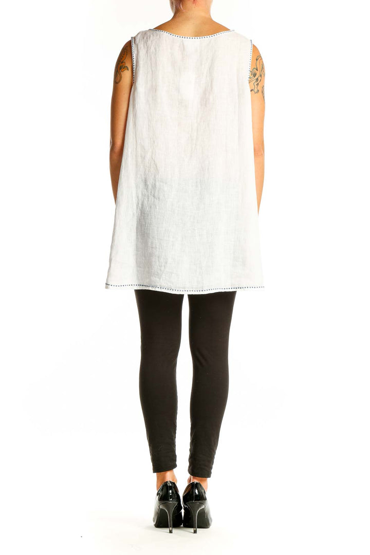 Side view of white linen sleeveless top showing relaxed fit