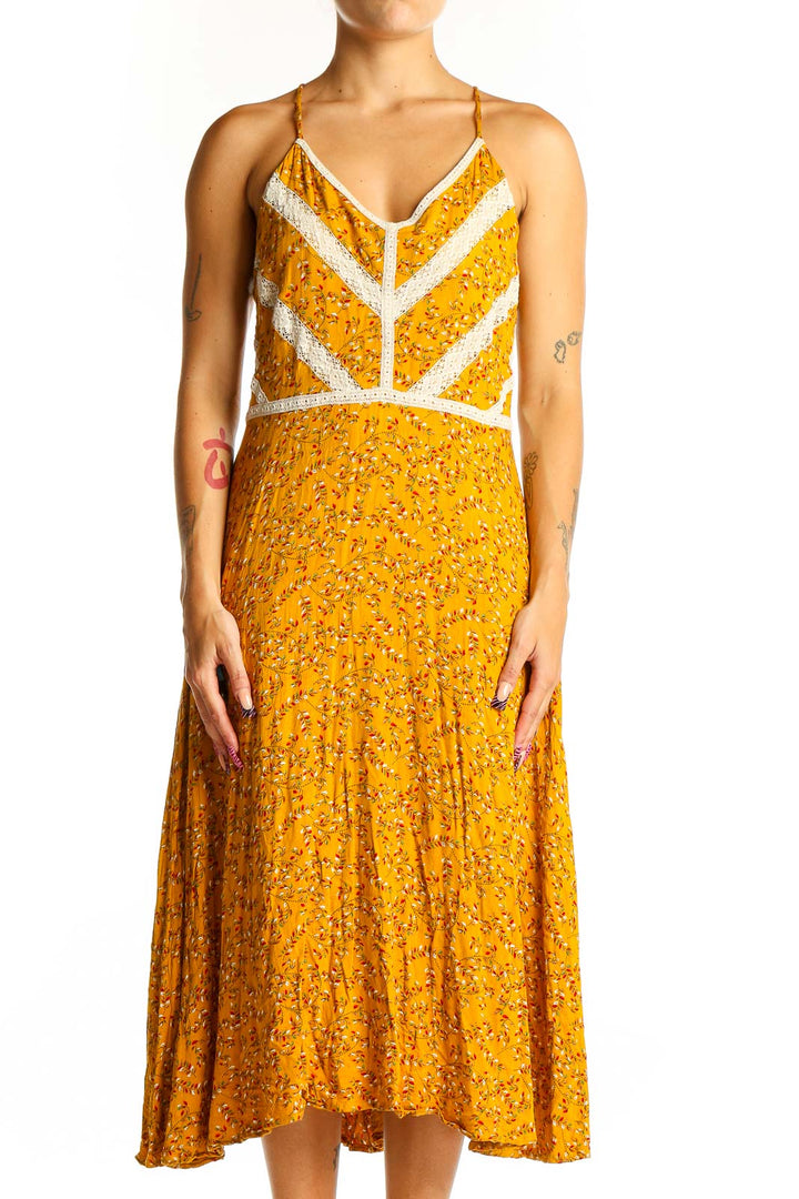 Front view of yellow floral Doe & Rae midi dress with white lace trim