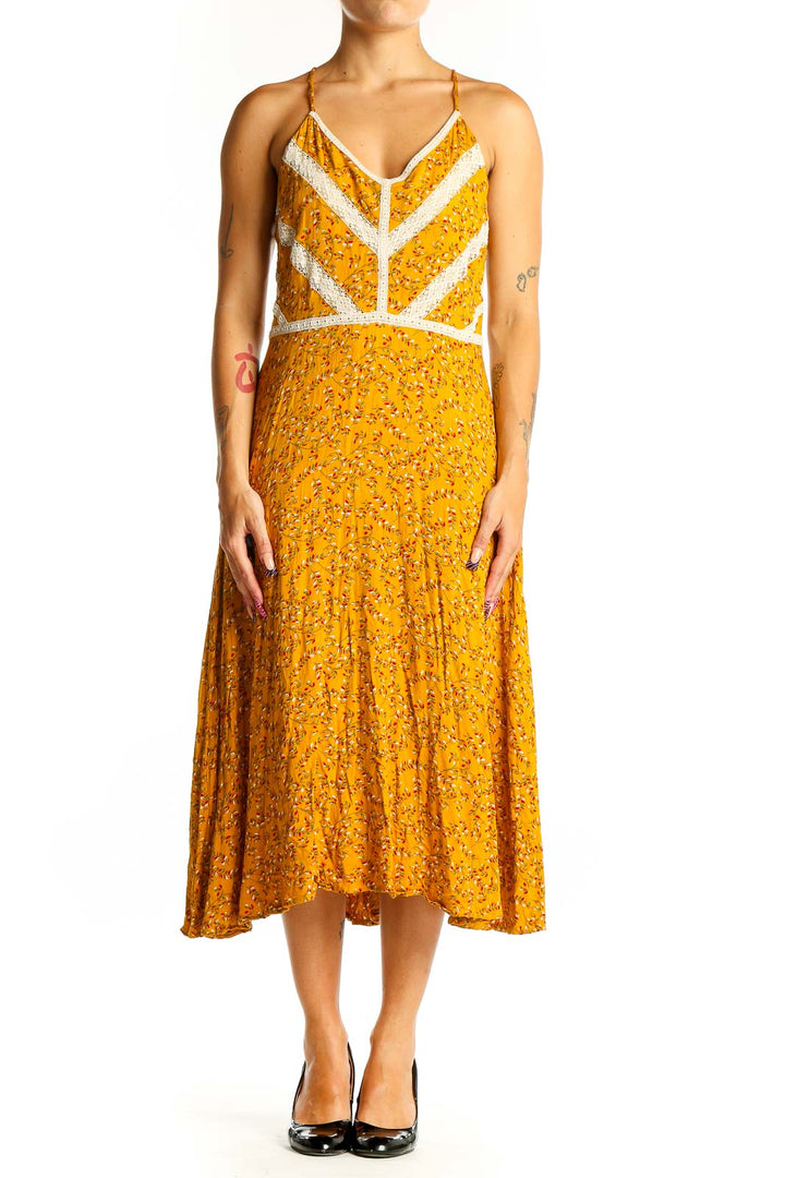 Front view of yellow floral Doe & Rae midi dress with white lace trim