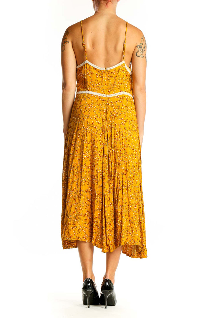 Side view of yellow floral Doe & Rae midi dress showing flowy skirt