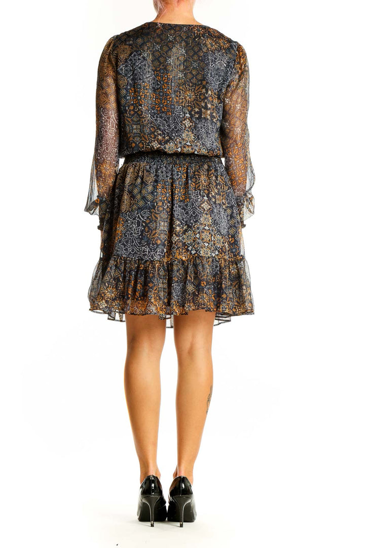 Side view of Michael Kors navy floral chiffon cocktail dress showing blouson bodice and tiered skirt