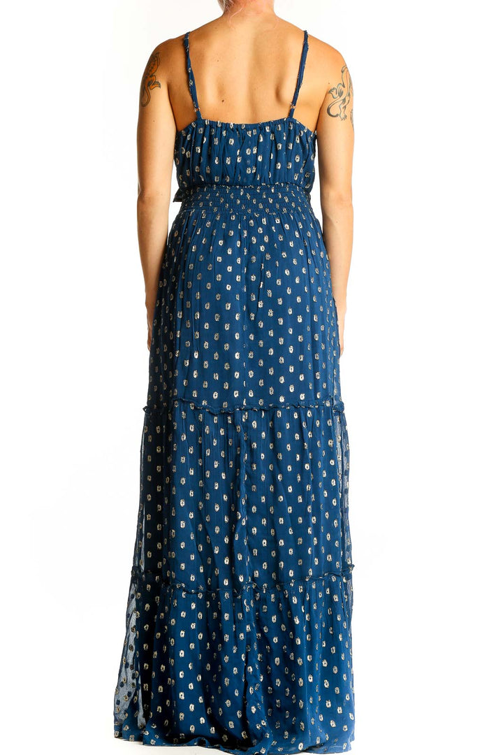 Back view of En Creme blue metallic polka dot maxi dress showing tiered skirt