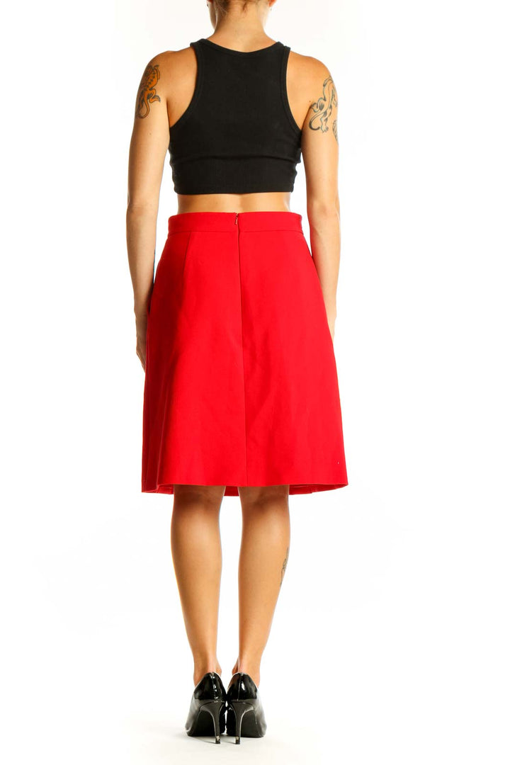 Side view of red Karen Millen A-line skirt with black top