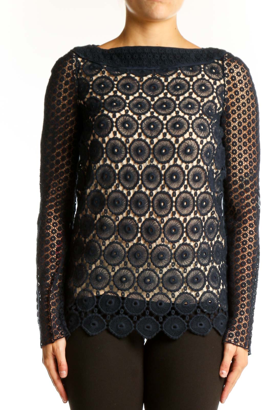 Front view of Tory Burch black lace top with circular floral pattern and nude underlay