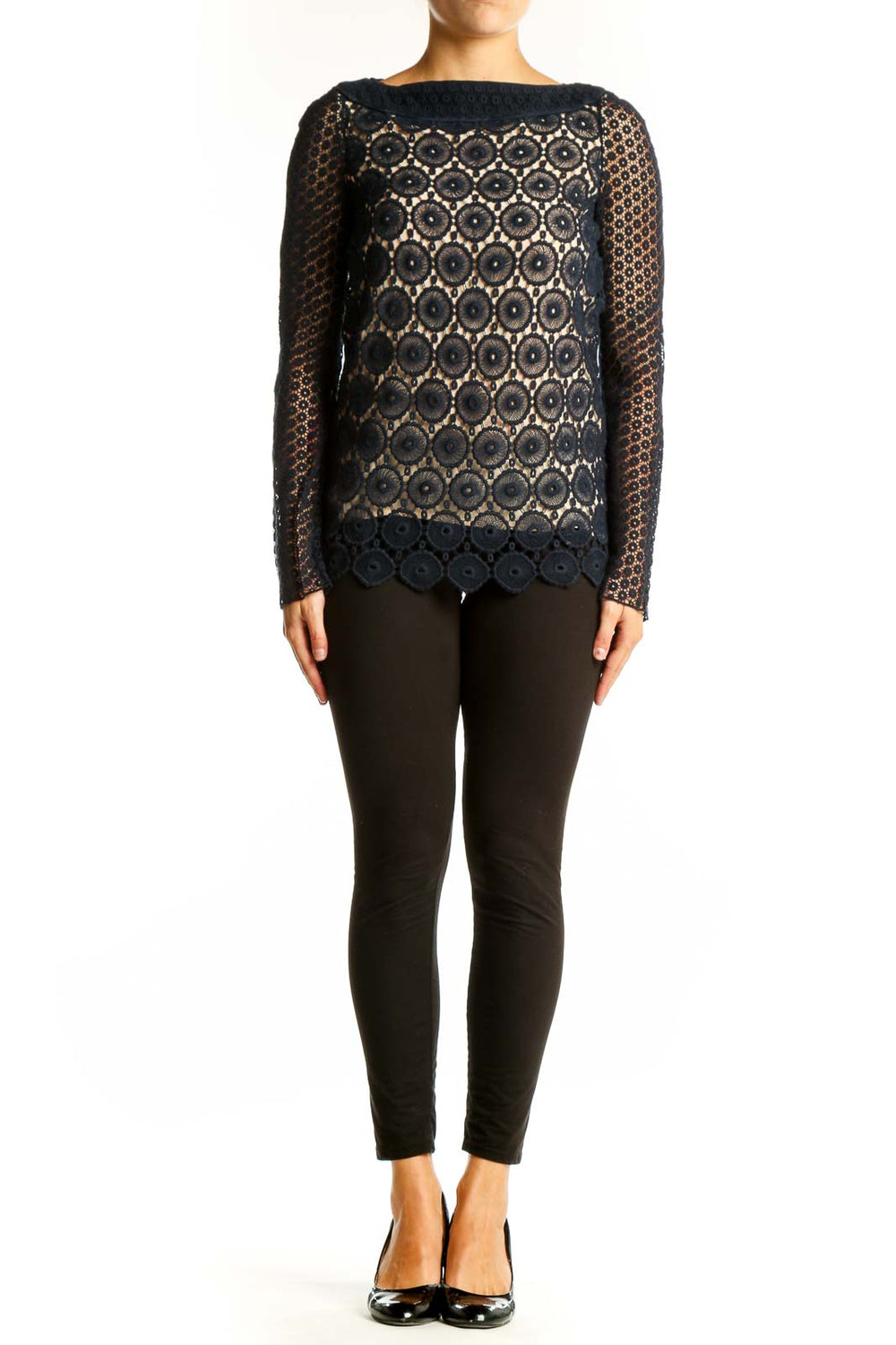 Front view of Tory Burch black lace top with circular floral pattern and nude underlay
