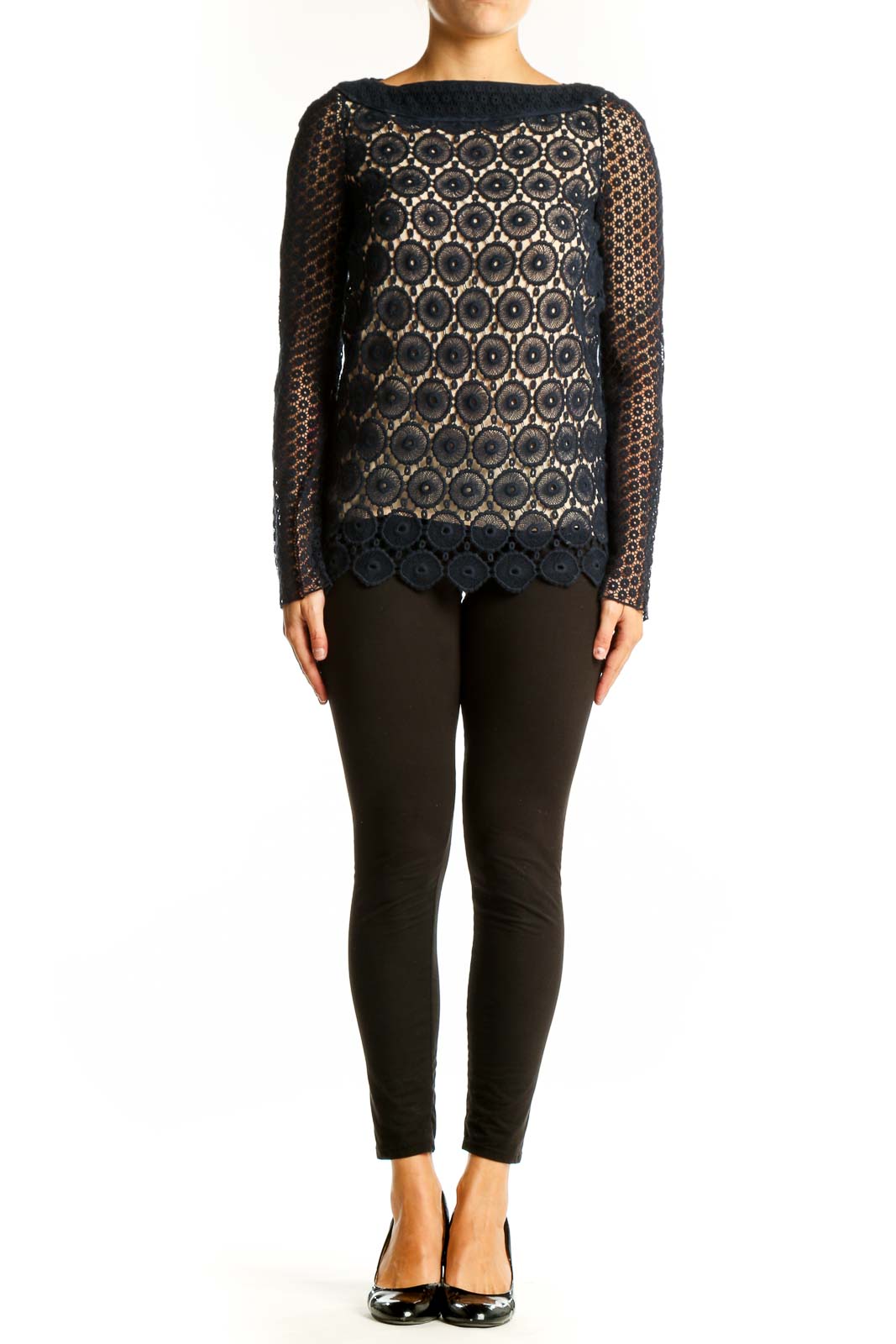 Front view of Tory Burch black lace top with circular floral pattern and nude underlay
