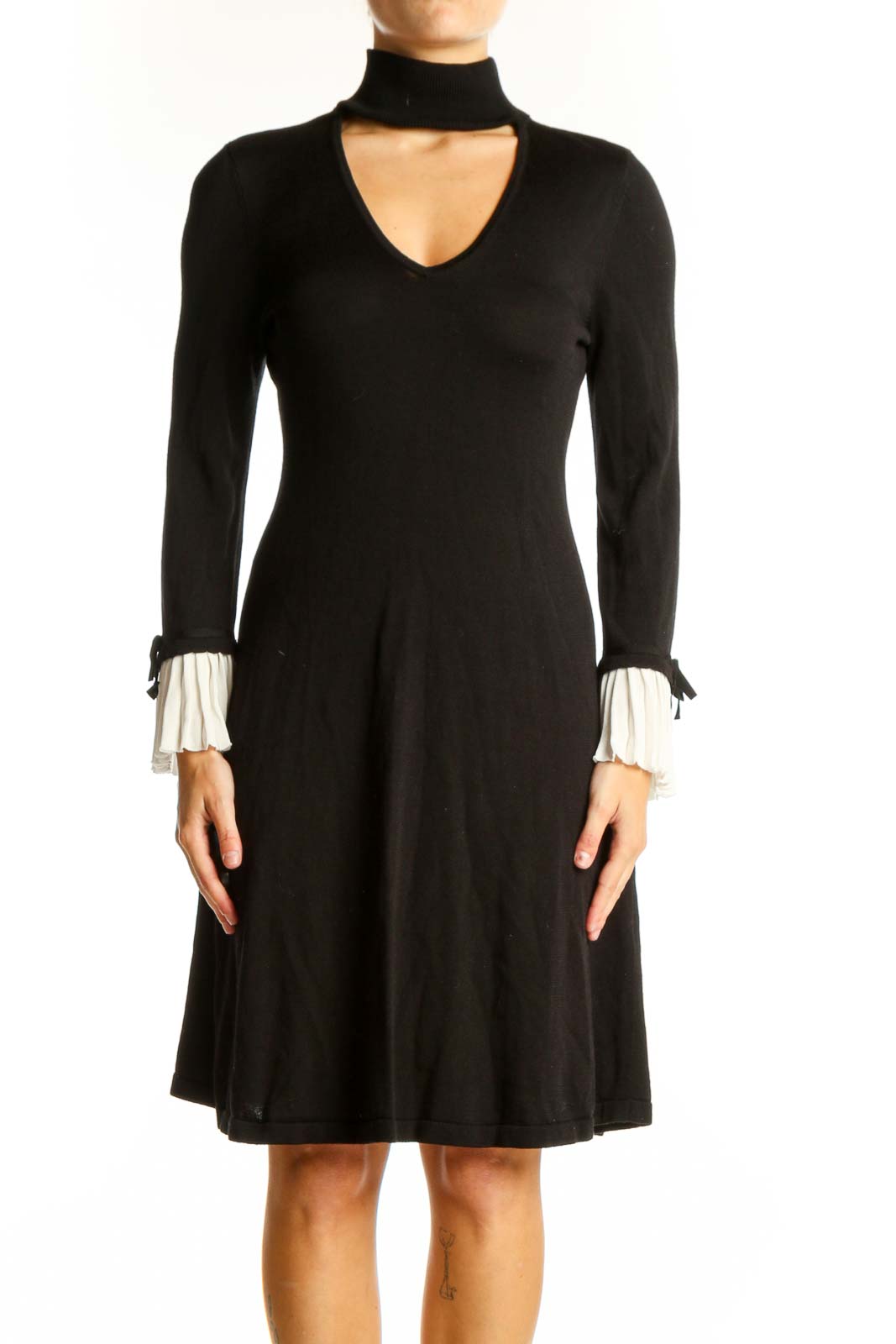 Front view of CeCe black choker neck flared dress with white pleated cuffs