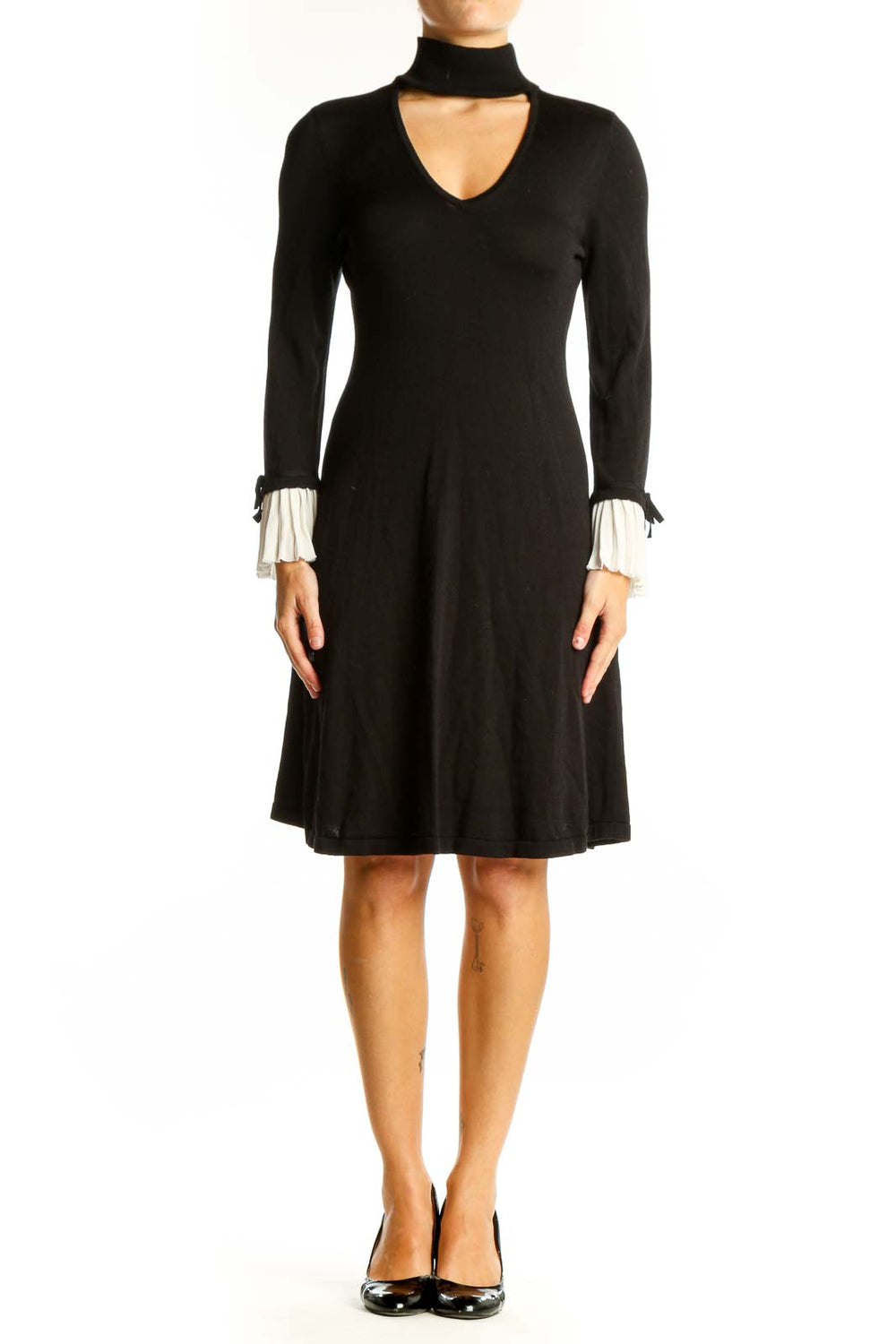 Front view of CeCe black choker neck flared dress with white pleated cuffs