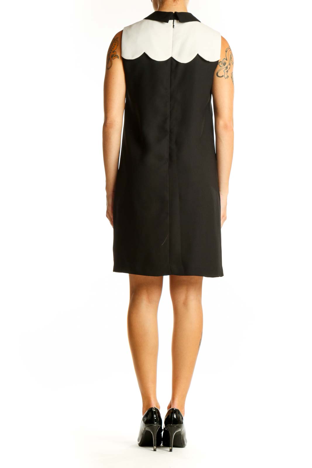 Side view of CeCe black sleeveless dress showing A-line silhouette