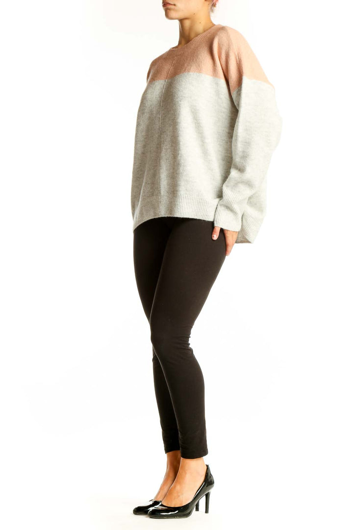 Front view of Vince Camuto peach and gray color block knit sweater