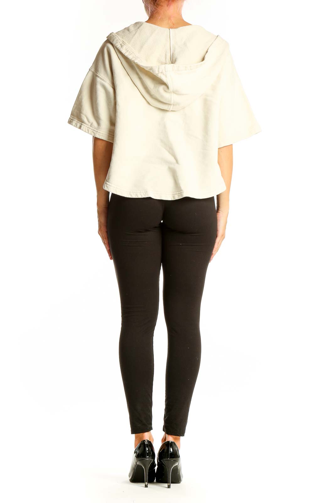 Back view of Joie cream cropped hooded cotton top on model with black pants