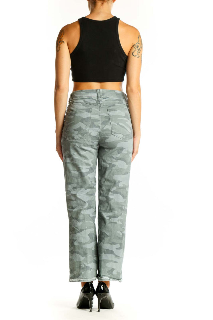 Side view of model wearing Wit & Wisdom sage green camo print wide-leg jeans with black crop top