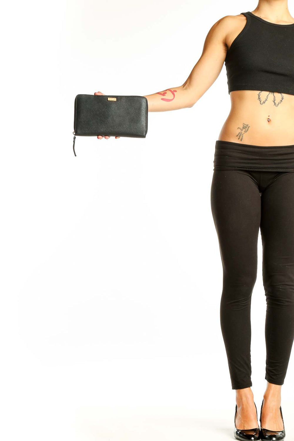 Front view of Kate Spade black leather clutch wallet held in hand