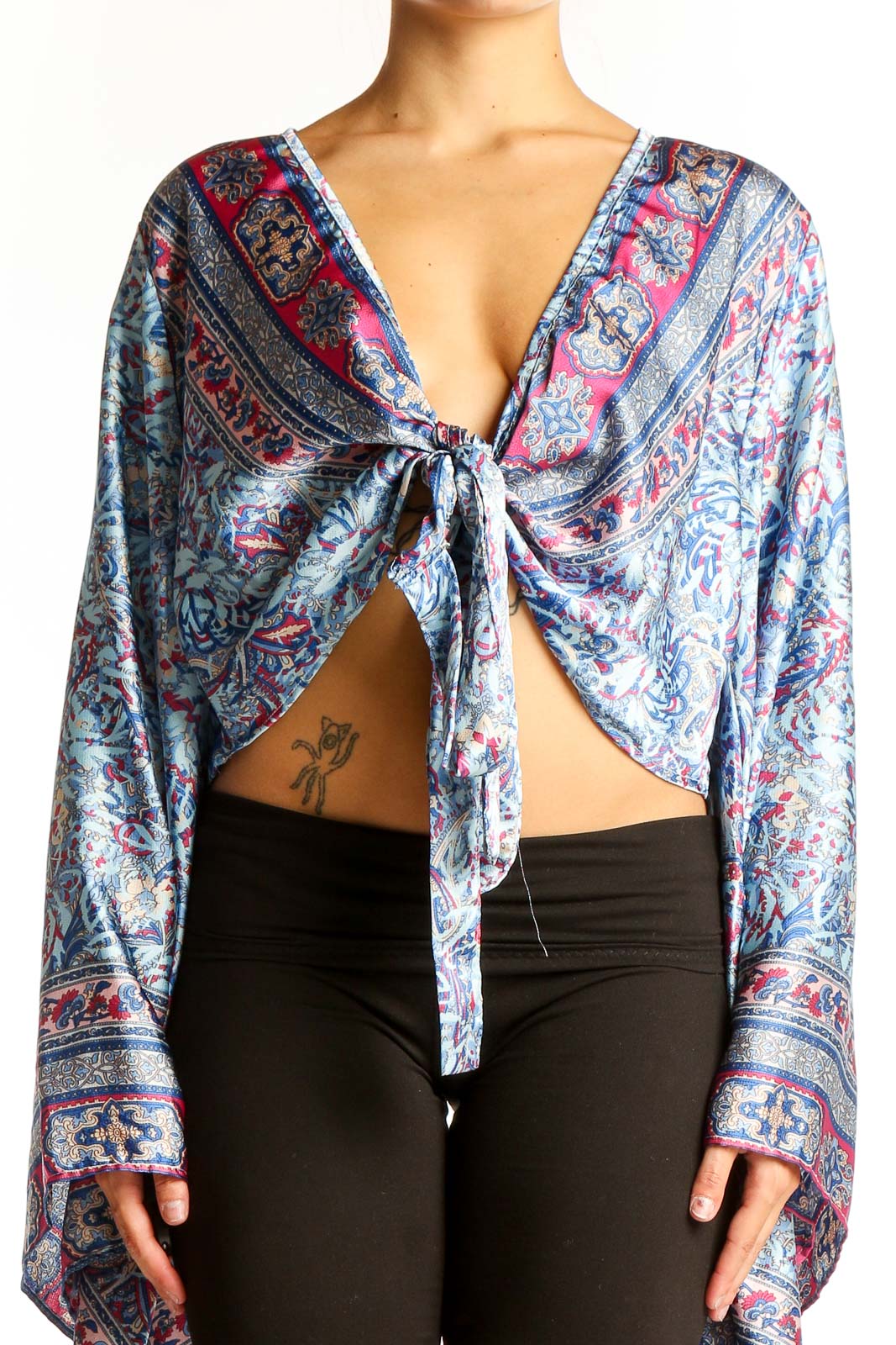 Front view of Galita Blue Floral Paisley Tie-Front Crop Top with long bell sleeves