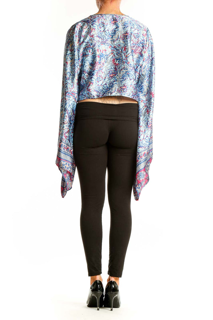 Side view of model wearing Galita Blue Floral Paisley Tie-Front Crop Top with black pants