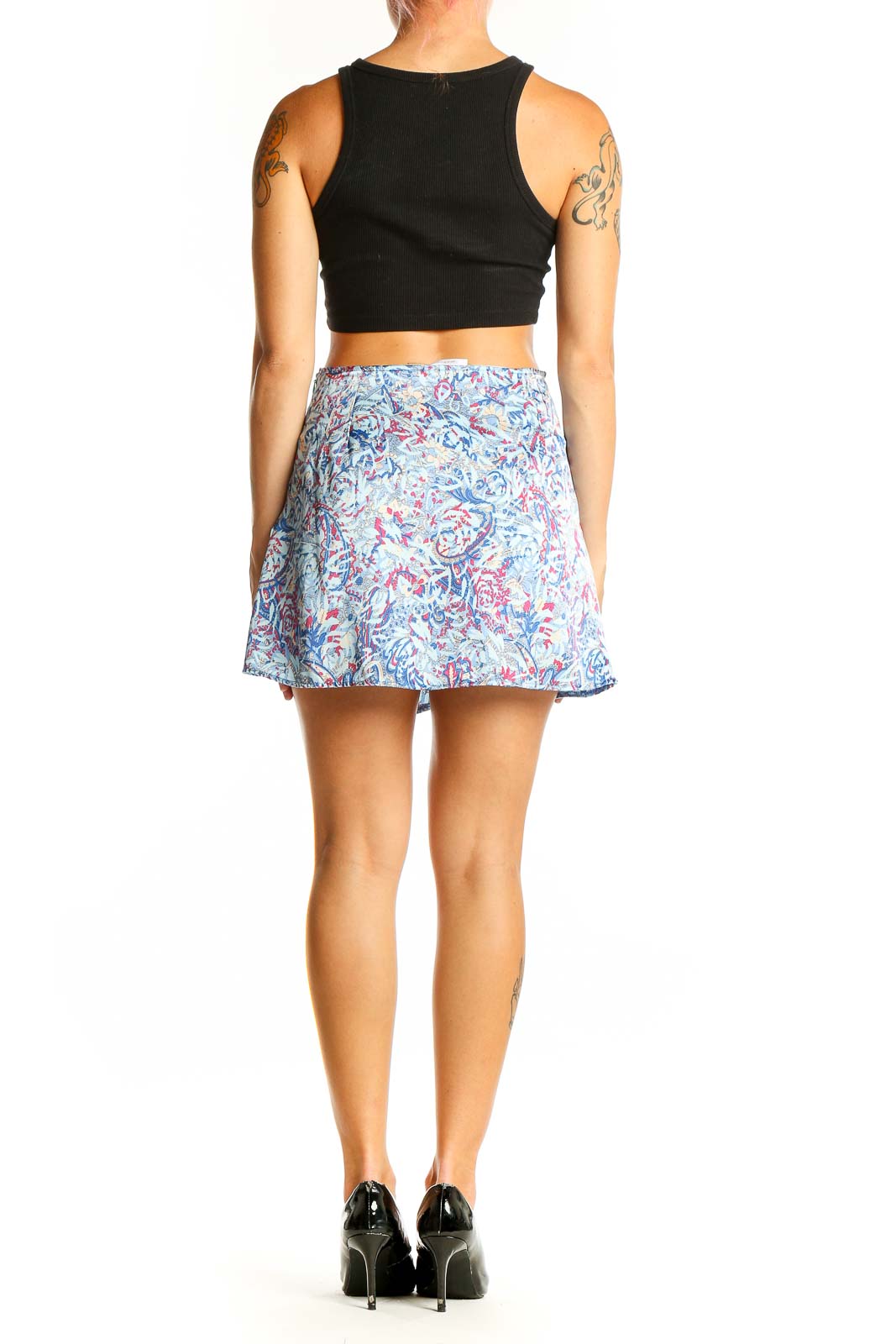 Side view of model wearing Galita blue floral print mini skirt with black top
