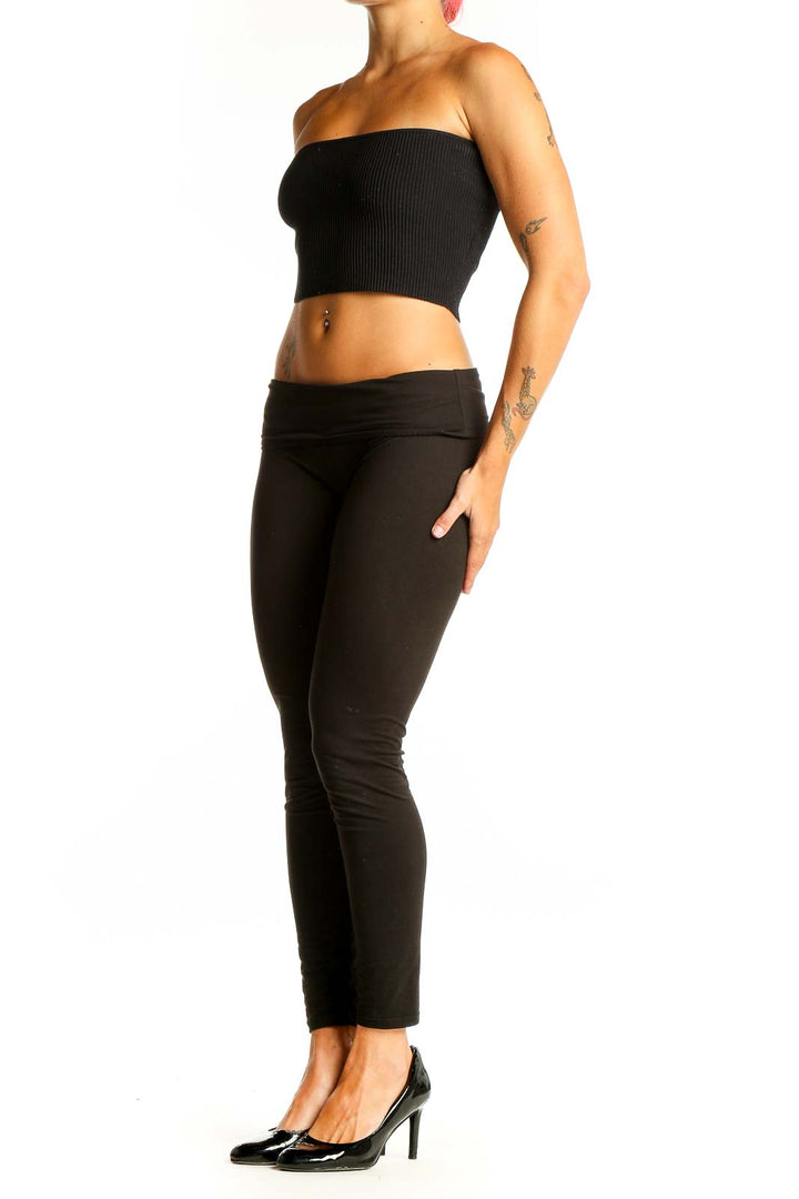 Front view of black ribbed strapless crop top on model