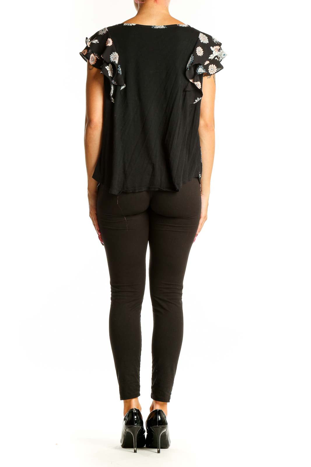 Side view of woman wearing LOFT Outlet black floral print top with black pants