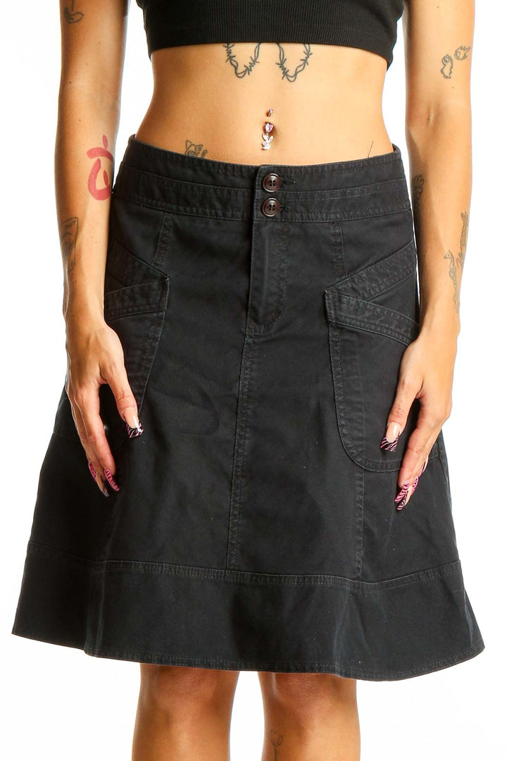 Front view of Nanette Lepore black denim A-line skirt with front pockets