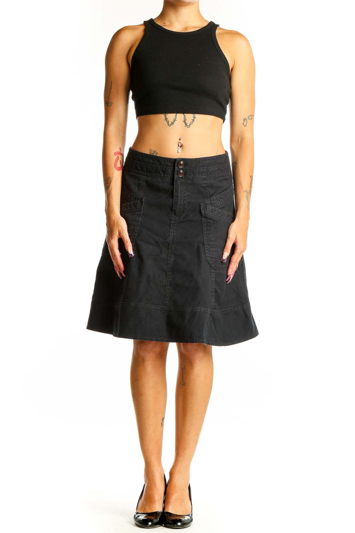 Front view of Nanette Lepore black denim A-line skirt with front pockets