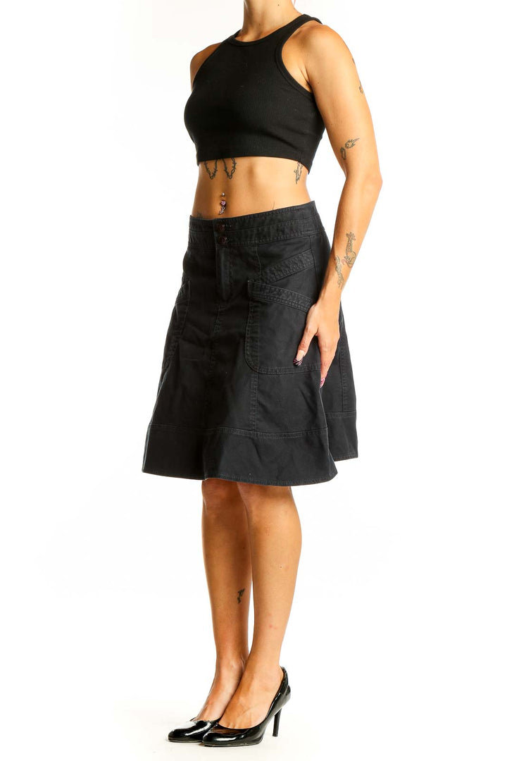 Front view of Nanette Lepore black denim A-line skirt with front pockets
