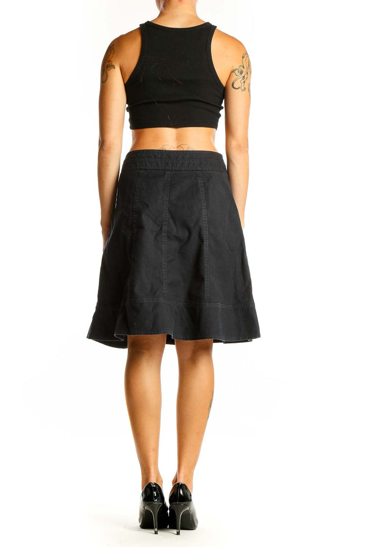 Side view of Nanette Lepore black denim A-line skirt on model