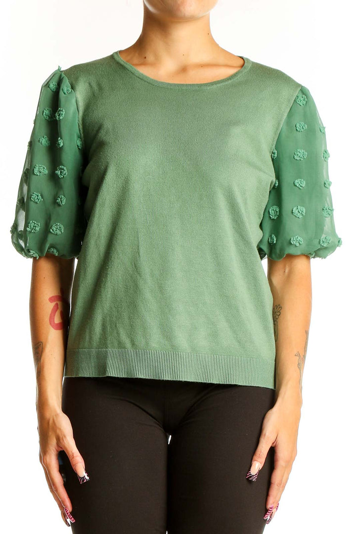 Front view of Adrianna Papell green knit top with floral appliqué puff sleeves