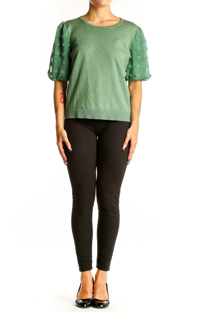 Front view of Adrianna Papell green knit top with floral appliqué puff sleeves