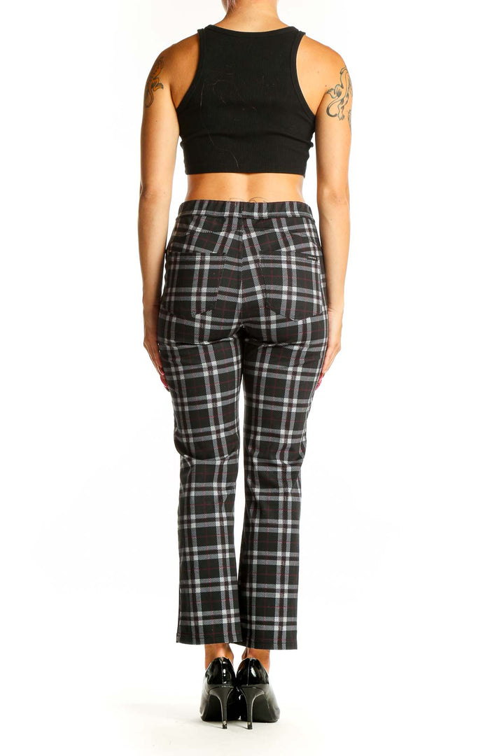 Side view of Sanctuary black plaid straight-leg trousers on model with black crop top