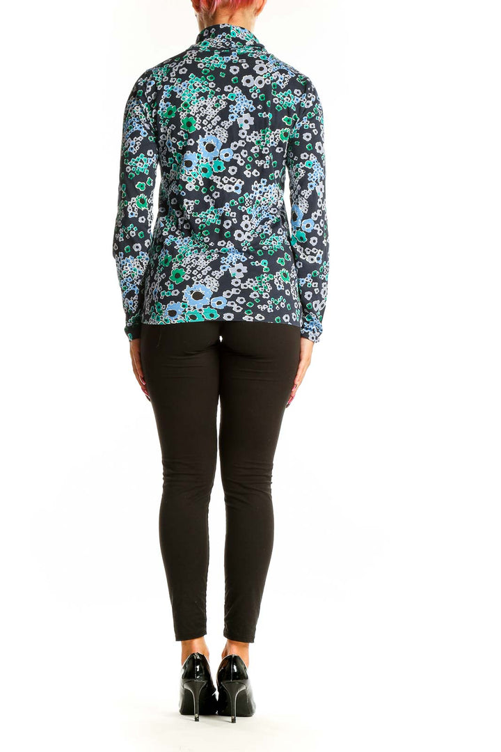 Side view of woman wearing J.Crew floral print turtleneck top with black pants