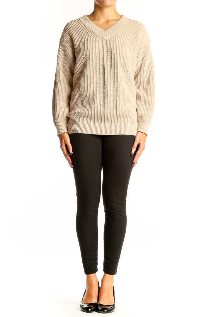 Front view of Uniqlo beige ribbed V-neck sweater on model