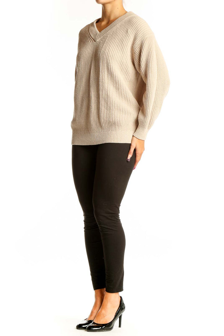 Front view of Uniqlo beige ribbed V-neck sweater on model